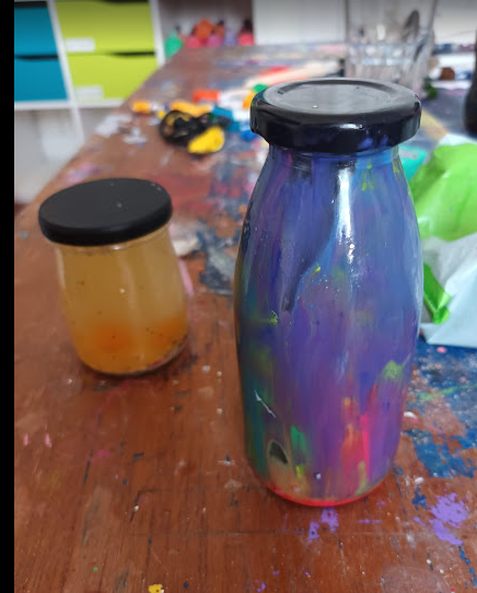 A bottle with paint on it AI-generated content may be incorrect.