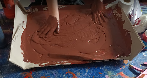 A person's hands on a tray of brown liquid AI-generated content may be incorrect.